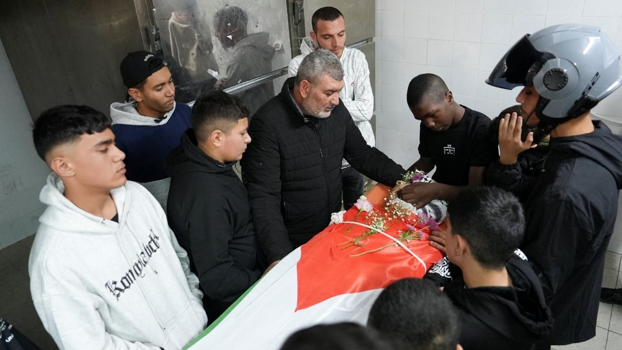 Relatives of one of two Palestinians, who were killed in an Israeli raid, react near their body ahead of their funeral, at a hospital in Ramallah, in the Israeli-occupied West Bank November 21, 2025. (Reuters/Ismael Khader)