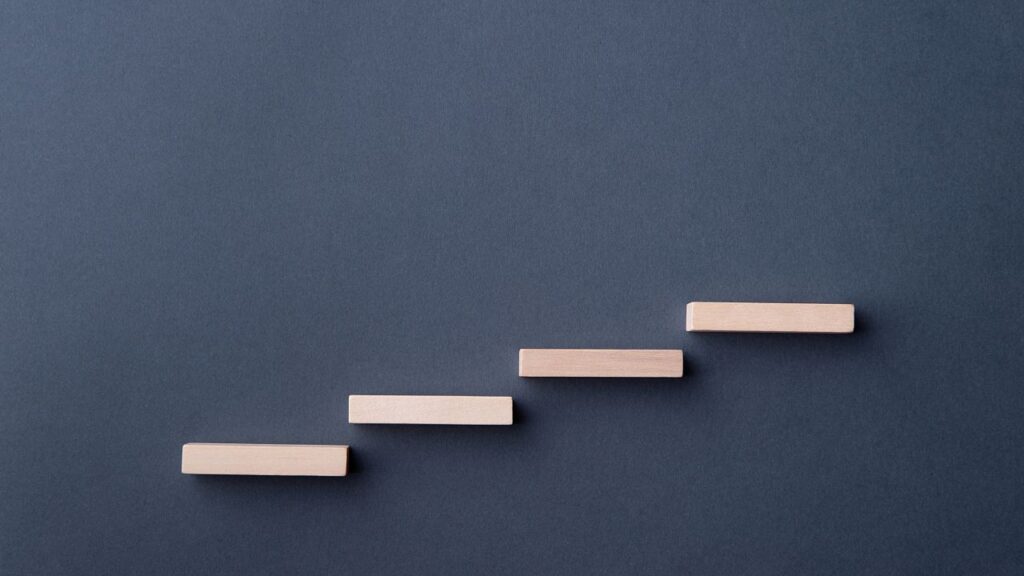 Image of ascending blocks symbolic of a stair case