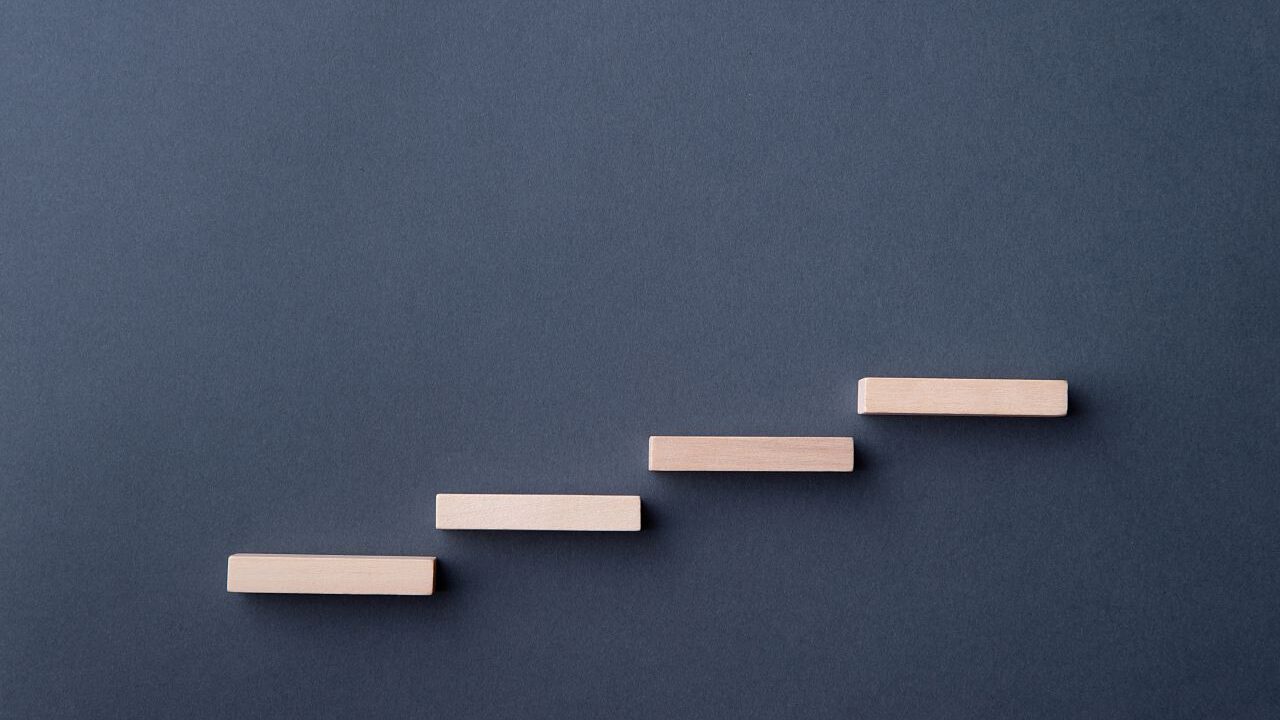 Image of ascending blocks symbolic of a stair case