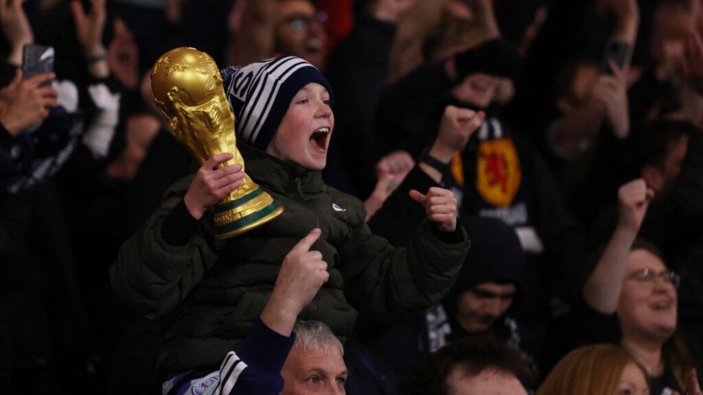 Soccer Football - FIFA World Cup - UEFA Qualifiers - Group C - Scotland v Denmark - Hampden Park, Glasgow, Scotland, Britain - November 18, 2025 Young Scotland fan with a replica World Cup trophy celebrates after they qualify for the World Cup Action Images via Reuters/Lee Smith