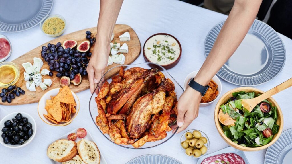 Image of two hands placing a Thanksgiving turkey on a table
