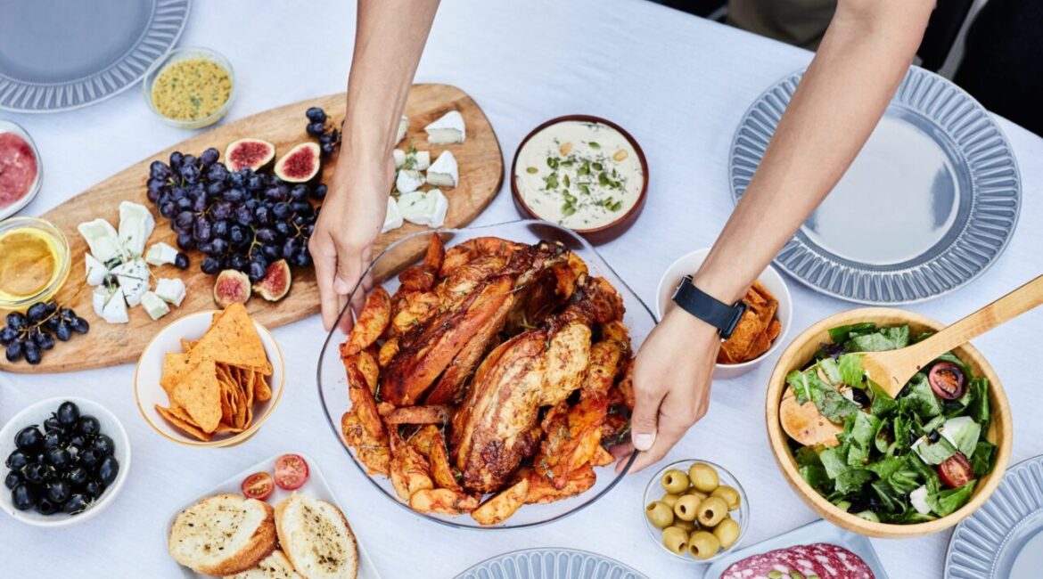 Image of two hands placing a Thanksgiving turkey on a table