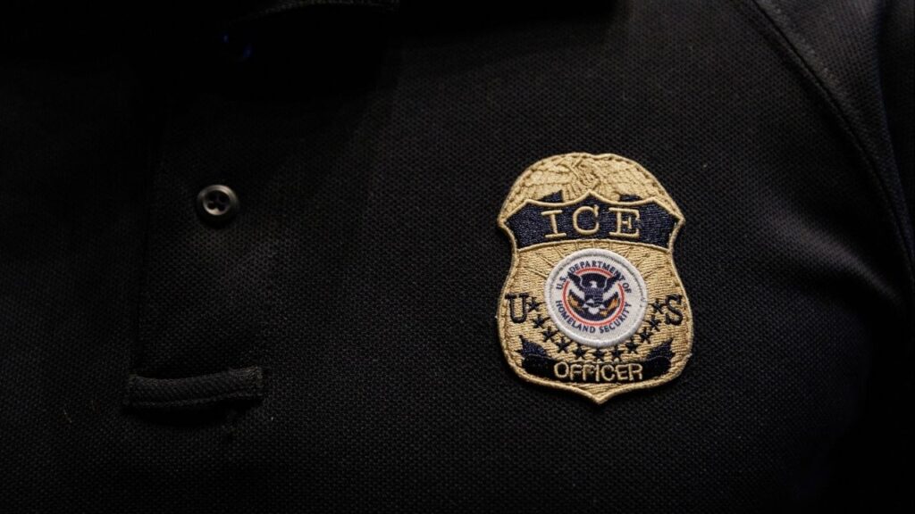 The badge of U.S. Immigration and Customs Enforcement (ICE) is embroidered on a polo shirt of an ICE employee in Arlington, Texas, U.S. August 26, 2025. (Reuters/Shelby Tauber)