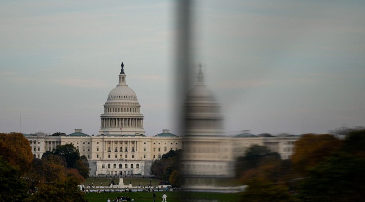 The dome of the U.S. Capitol is reflected in a window as people visit the Washington Monument, more than a month into the continuing U.S. government shutdown in Washington, D.C., U.S., November 2, 2025. (Reuters/Kent Nishimura)