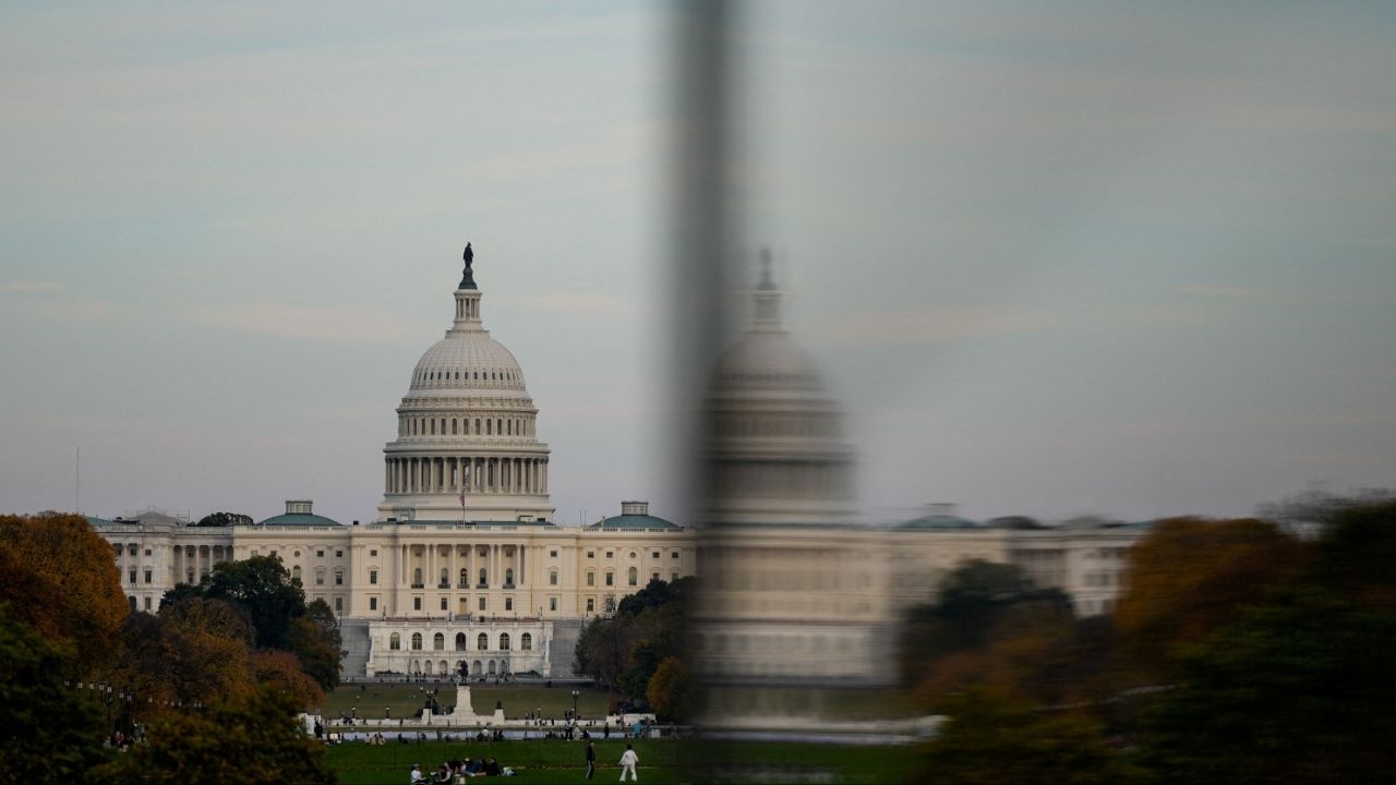 The dome of the U.S. Capitol is reflected in a window as people visit the Washington Monument, more than a month into the continuing U.S. government shutdown in Washington, D.C., U.S., November 2, 2025. (Reuters/Kent Nishimura)