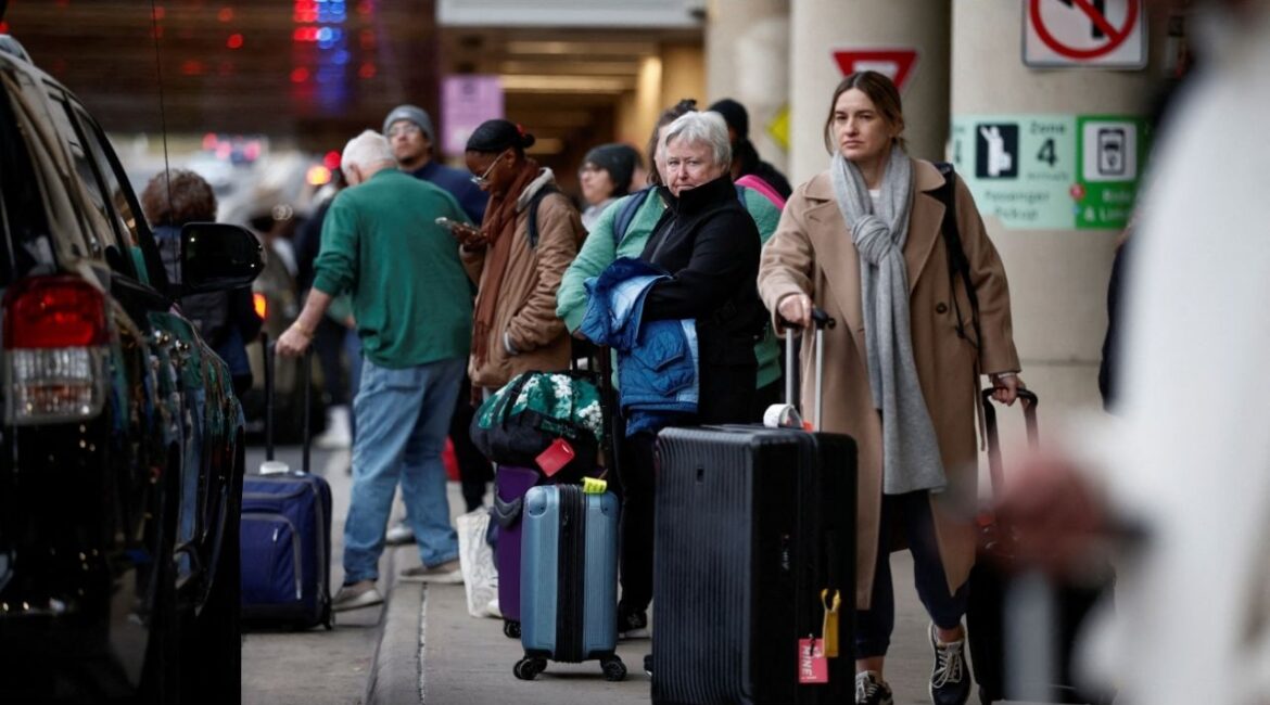 Travelers wait at a ride-sharing and taxi pickup area at Ronald Reagan National Airport (DCA) ahead of the Thanksgiving holiday in Arlington, Virginia, U.S., November 27, 2024. (Reuters File)