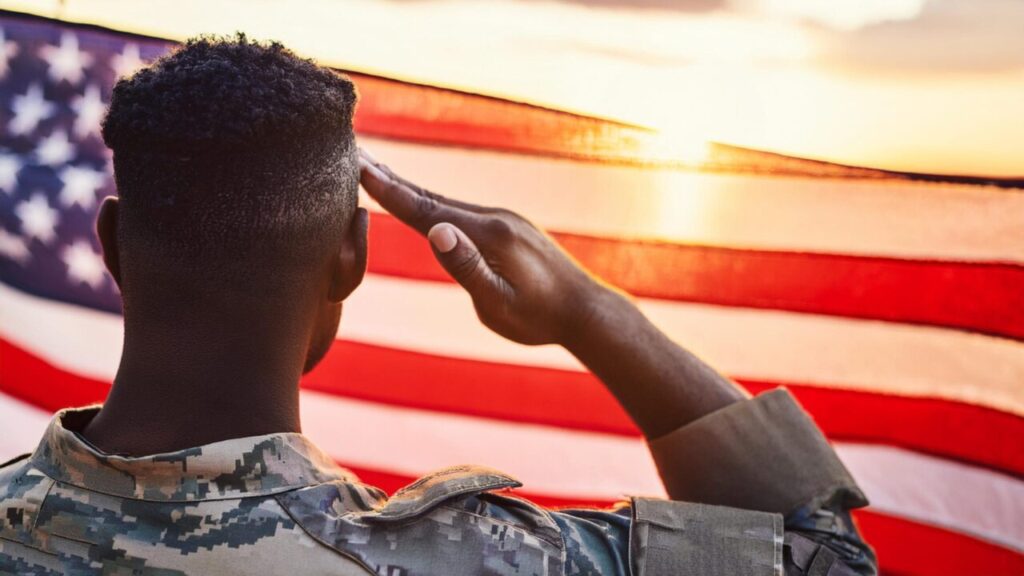 Image of a soldier saluting the American flag in honor of veterans day