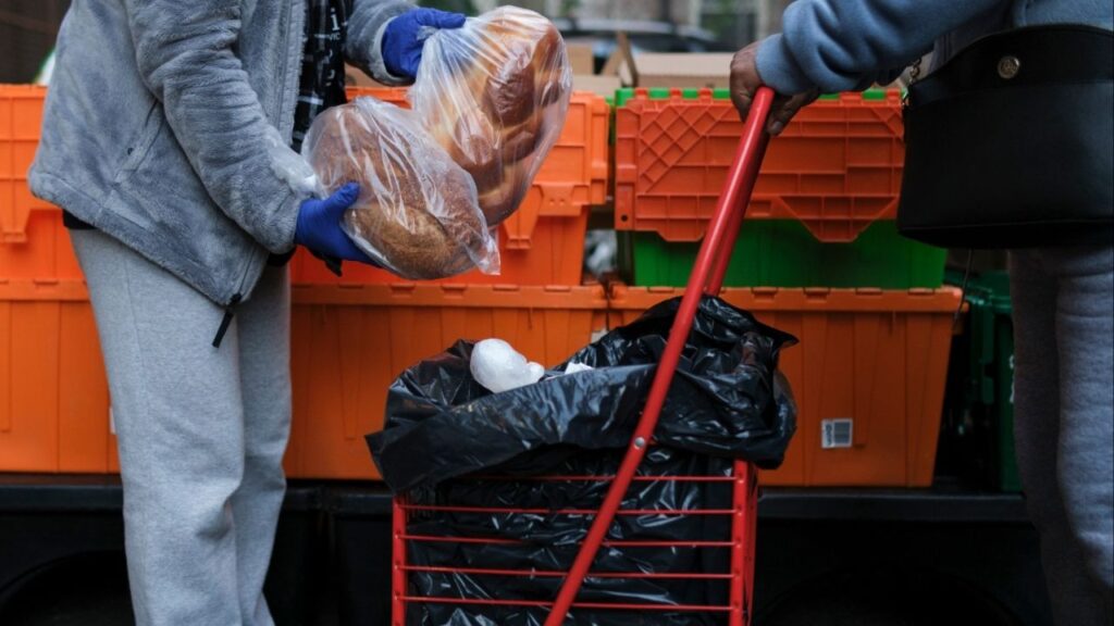 Volunteers distribute groceries at the Church of the Good Shepherd food pantry in Manhattan, Nov. 1, 2025. The Trump administration told states that they must “immediately undo” any actions to provide full food stamp benefits to low-income families, in a move that added to the chaos and uncertainty surrounding the nation’s largest anti-hunger program during the government shutdown. (Marco Postigo Storel/The New York Times)