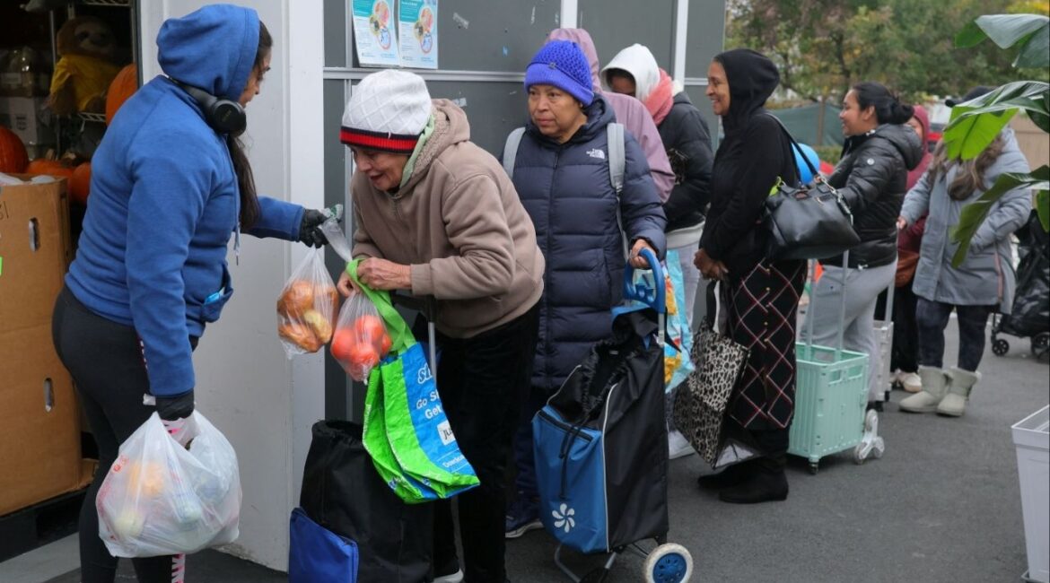 Workers distribute groceries at La Colaborativa’s food pantry, as food aid benefits, including SNAP payments, will be suspended starting November 1 amid the ongoing U.S. government shutdown, in Chelsea, Massachusetts, U.S., October 29, 2025. (Reuters/Brian Snyder)