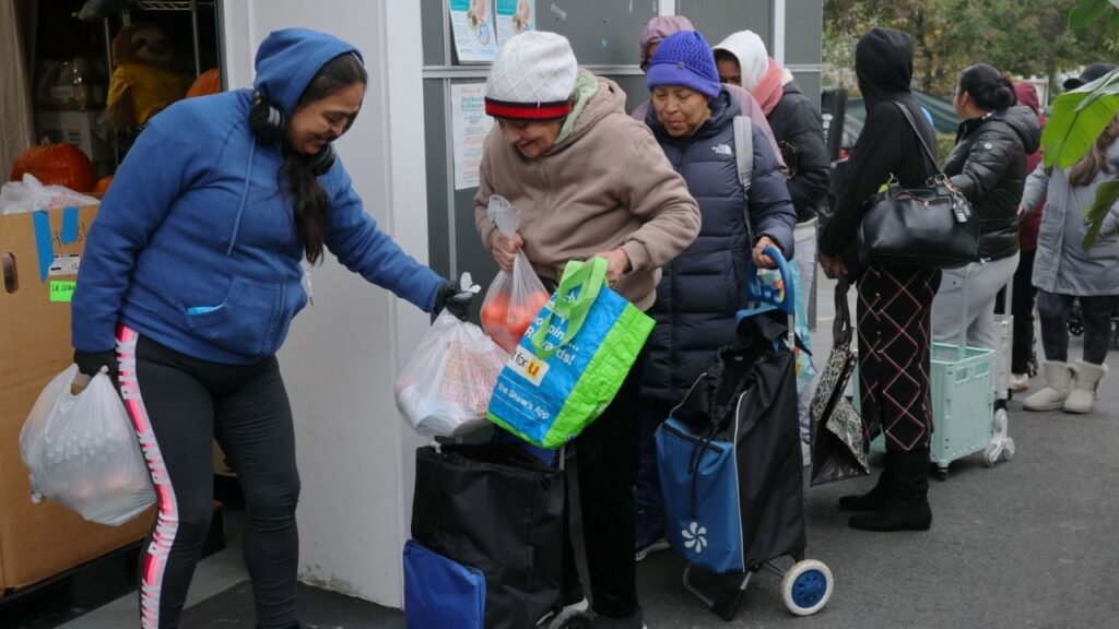 Workers distribute groceries at La Colaborativa’s food pantry in Chelsea, Massachusetts, U.S., October 29, 2025. (Reuters/Brian Snyder)
