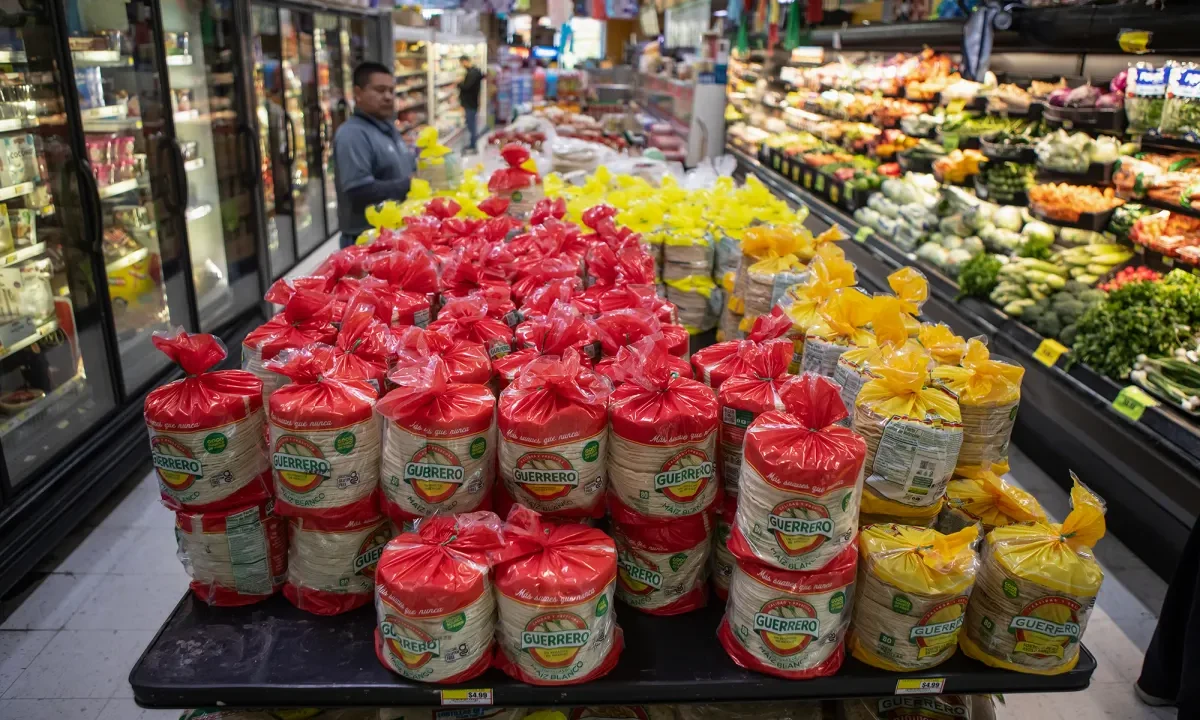 Image of stacks of tortillas on a table in the aisle of a supermarkets