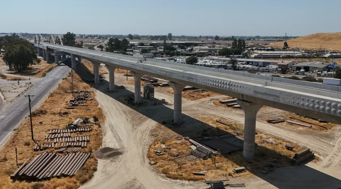 Image of a concrete high-speed rail ramp under construction and pipes on the ground below