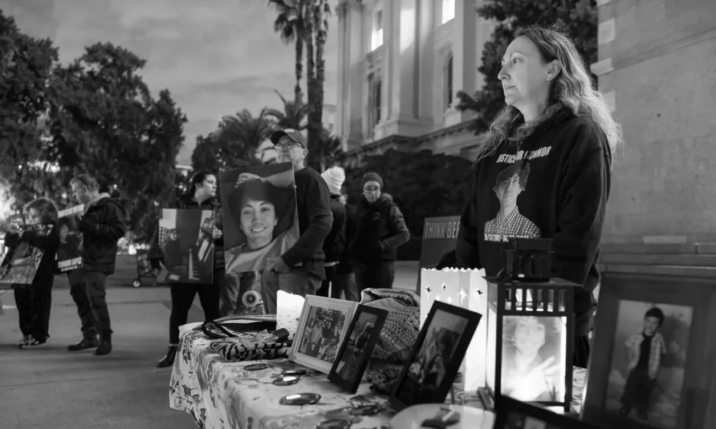 Black and white image of attendees at a vigil for people killed by drunk drivers