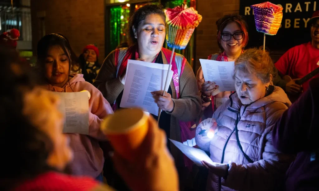 Image of women singing in a small festive room as part of a Latino Christmas tradition