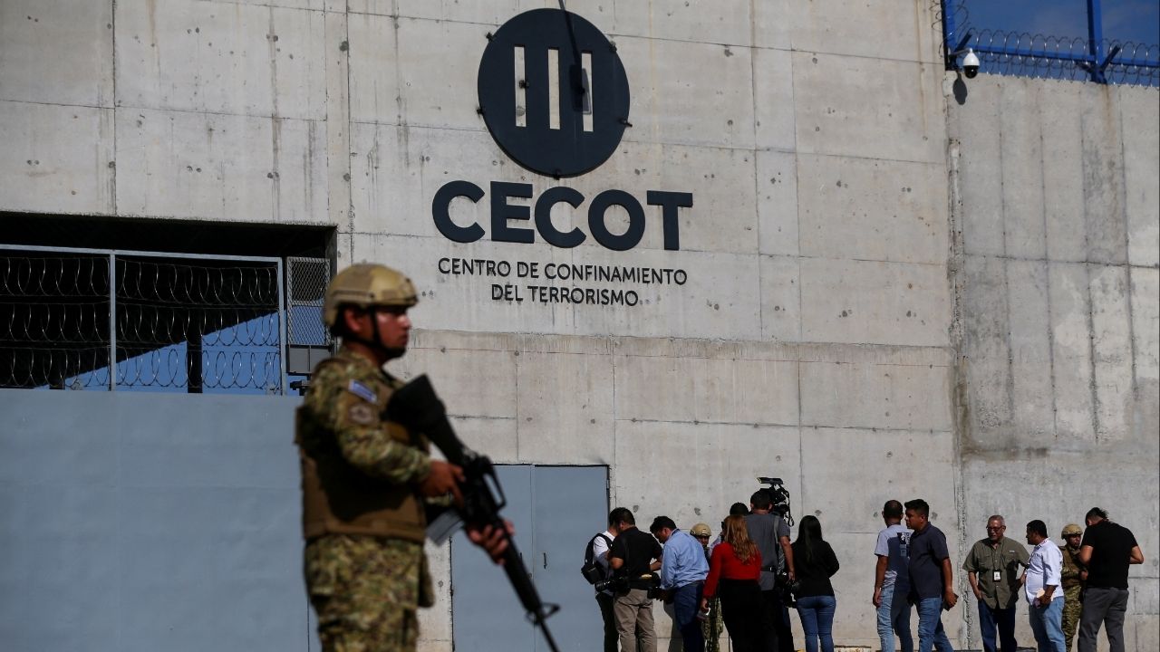 A Salvadoran soldier stands guard, as the CECOT logo is seen, during a media tour at the Terrorism Confinement Center (CECOT) prison, in Tecoluca, El Salvador April 4, 2025. (Reuters/Jose Cabezas)