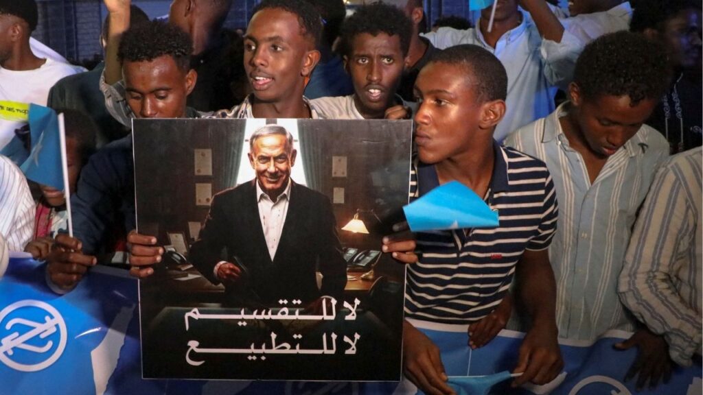 A demonstrator holds an image depicting Israeli Prime Minister Benjamin Netanyahu as Somalis attend a demonstration after Israel became the first country to formally recognize the self-declared Republic of Somaliland as an independent and sovereign state, a decision that could reshape regional dynamics and test Somalia's longstanding opposition to secession, in Hodan district of Mogadishu, Somalia, December 28, 2025. (Reuters/Feisal Omar)