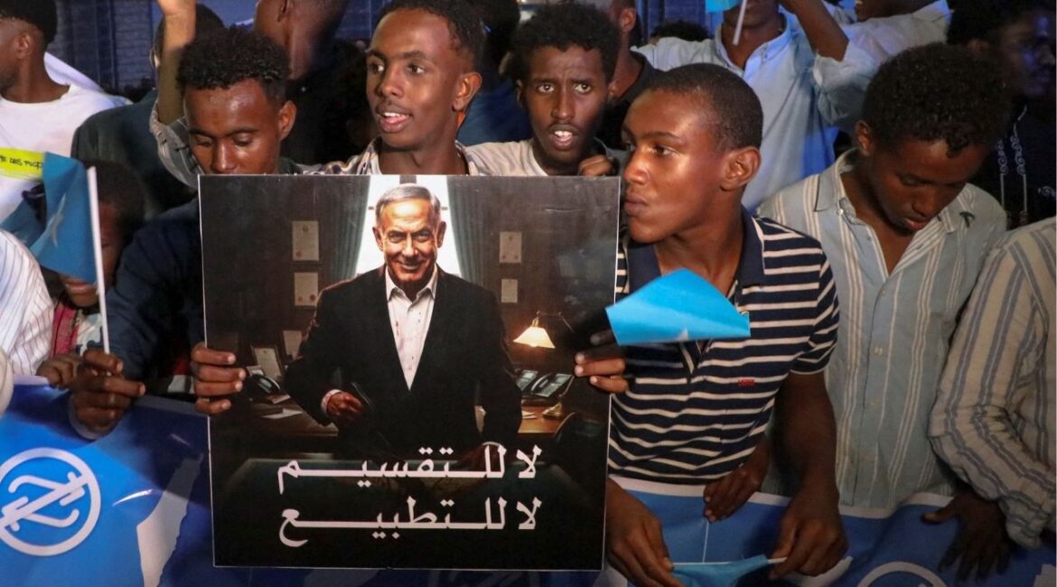 A demonstrator holds an image depicting Israeli Prime Minister Benjamin Netanyahu as Somalis attend a demonstration after Israel became the first country to formally recognize the self-declared Republic of Somaliland as an independent and sovereign state, a decision that could reshape regional dynamics and test Somalia's longstanding opposition to secession, in Hodan district of Mogadishu, Somalia, December 28, 2025. (Reuters/Feisal Omar)