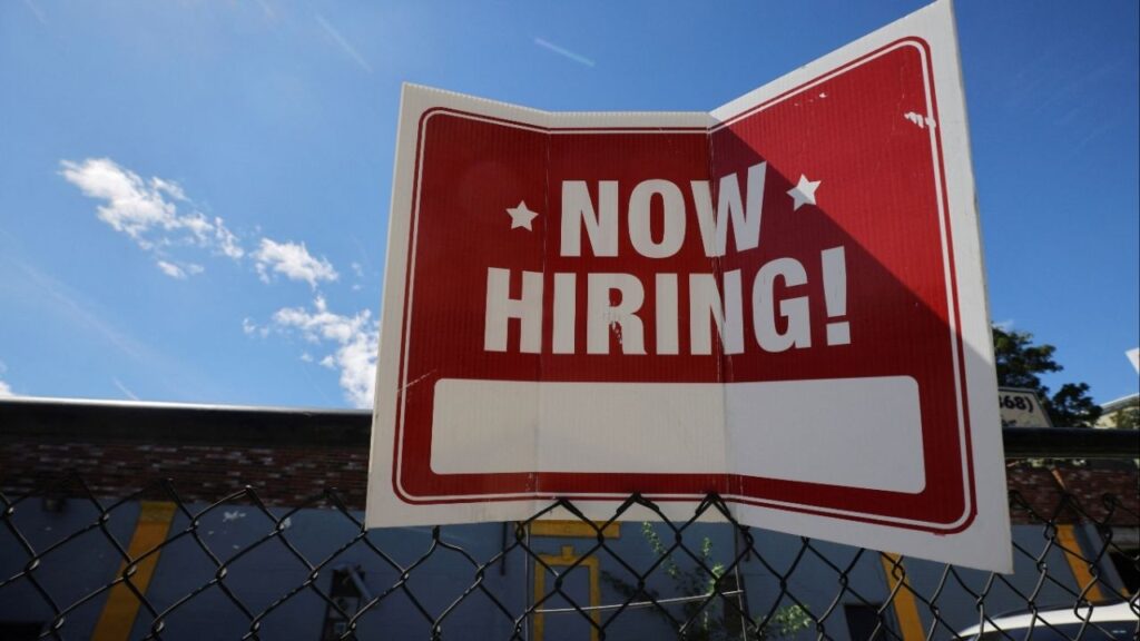 A "now hiring" sign is displayed outside Taylor Party and Equipment Rentals in Somerville, Massachusetts, U.S., September 1, 2022. (Reuters/Brian Snyder)