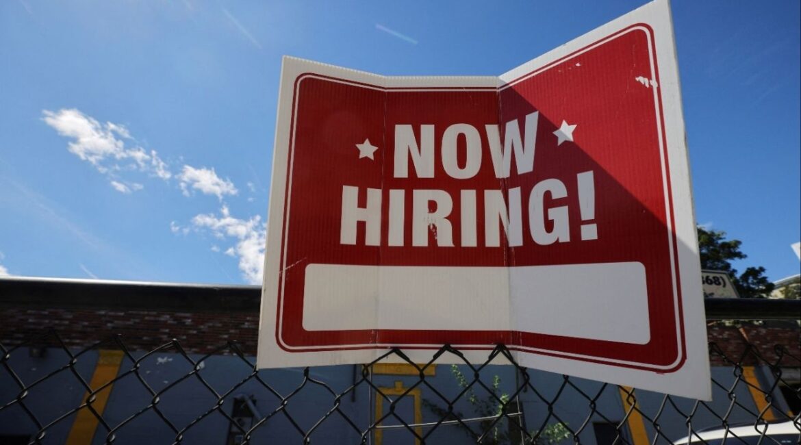 A "now hiring" sign is displayed outside Taylor Party and Equipment Rentals in Somerville, Massachusetts, U.S., September 1, 2022. (Reuters/Brian Snyder)