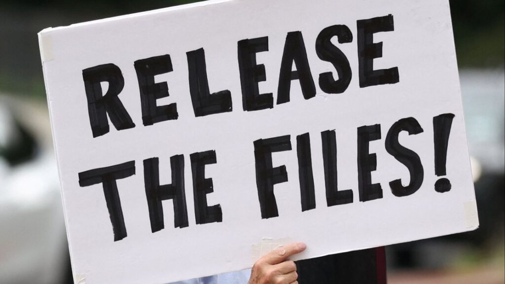 A protester calling for a release of the Epstein files holds a sign while awaiting the arrival of Trump administration officials who are expected to discuss strategy amid the deepening political crisis over the administration’s handling of files related to convicted sex offender Jeffrey Epstein, at the U.S. Naval Observatory, Vice President JD Vance's official residence, in Washington, D.C., U.S., August 6, 2025. (Reuters/Kevin Lamarque)
