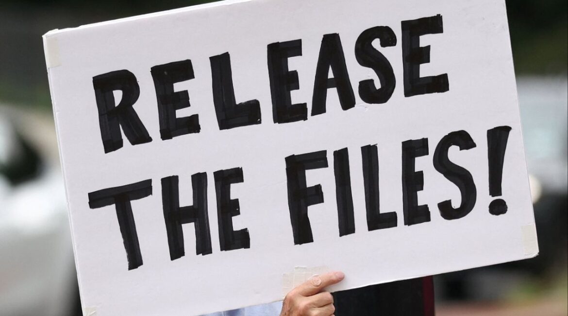 A protester calling for a release of the Epstein files holds a sign while awaiting the arrival of Trump administration officials who are expected to discuss strategy amid the deepening political crisis over the administration’s handling of files related to convicted sex offender Jeffrey Epstein, at the U.S. Naval Observatory, Vice President JD Vance's official residence, in Washington, D.C., U.S., August 6, 2025. (Reuters/Kevin Lamarque)