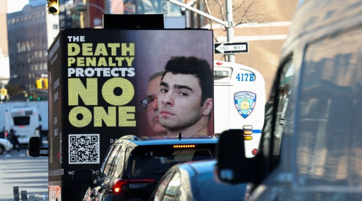 A screen displays a picture of Luigi Mangione, the suspect in the killing of UnitedHealthcare chief executive Brian Thompson, ahead of his appearance for a pre-trial hearing on murder charges, in New York City, New York, U.S., December 1, 2025. (Reuters/Mike Segar)