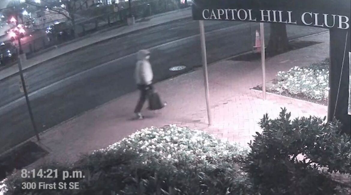 A suspect in the planting of explosive devices near the Democratic and Republican committee headquarters in Washington is seen walking past the Capitol Hill Club, also known as the National Republican Club of Capitol Hill, in Washington in this still frame taken from video released on March 9, 2021. (FBI/Handout via Reuters)