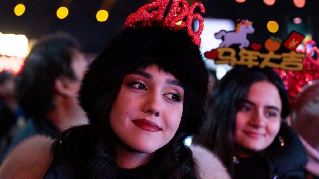 A woman looks on during a New Year countdown ceremony at the Juyongguan section of the Great Wall, also known as Juyong Pass, in Beijing, China, December 31, 2025. REUTERS/Maxim Shemetov