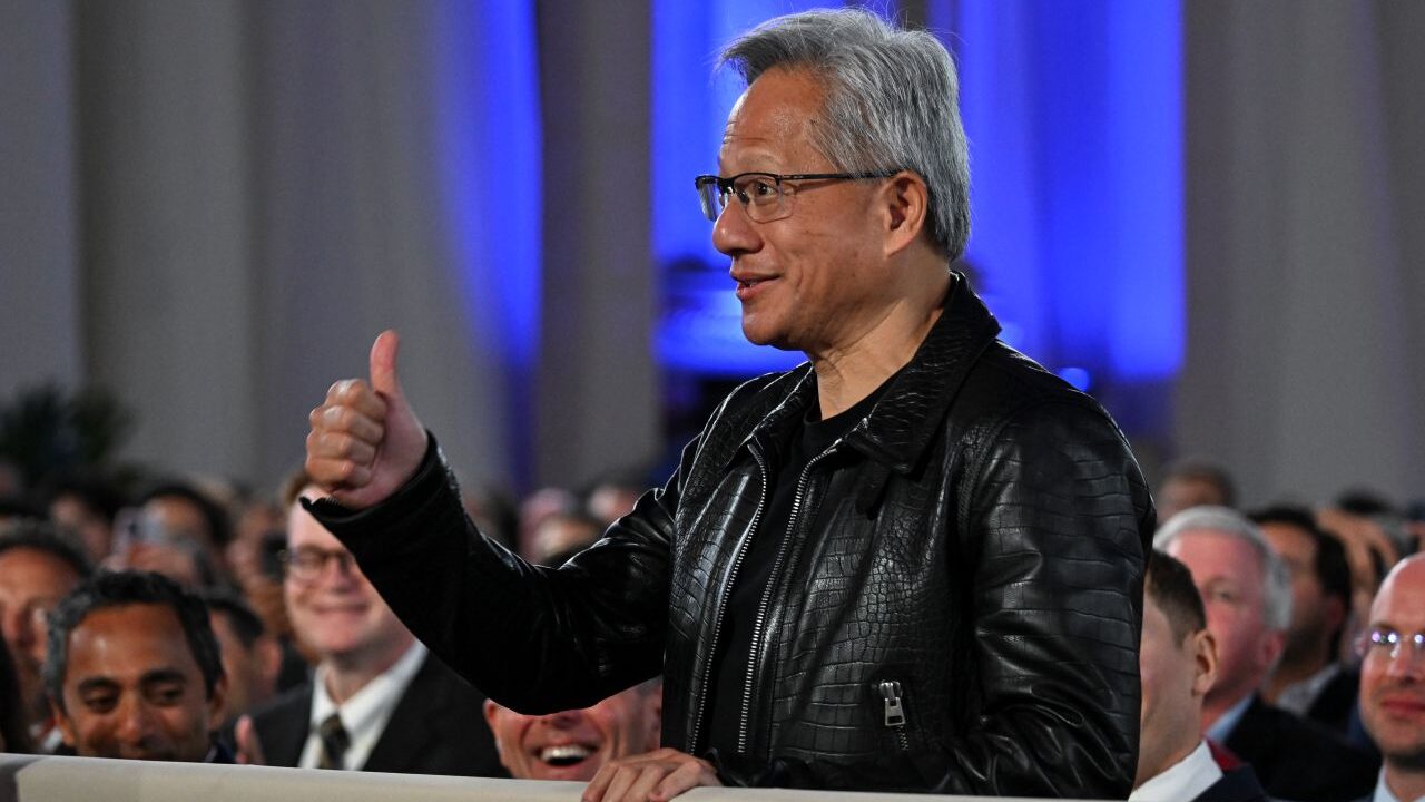 Image of Jensen Huang, in a black shirt and black leather jacket, giving a thumb's up.