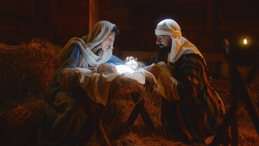 Illustration of Mary and Joseph with newborn Jesus in the manger
