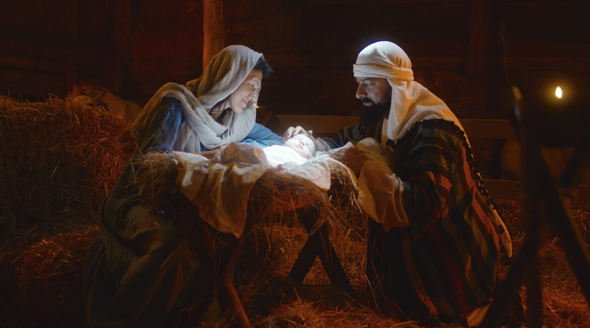Illustration of Mary and Joseph with newborn Jesus in the manger