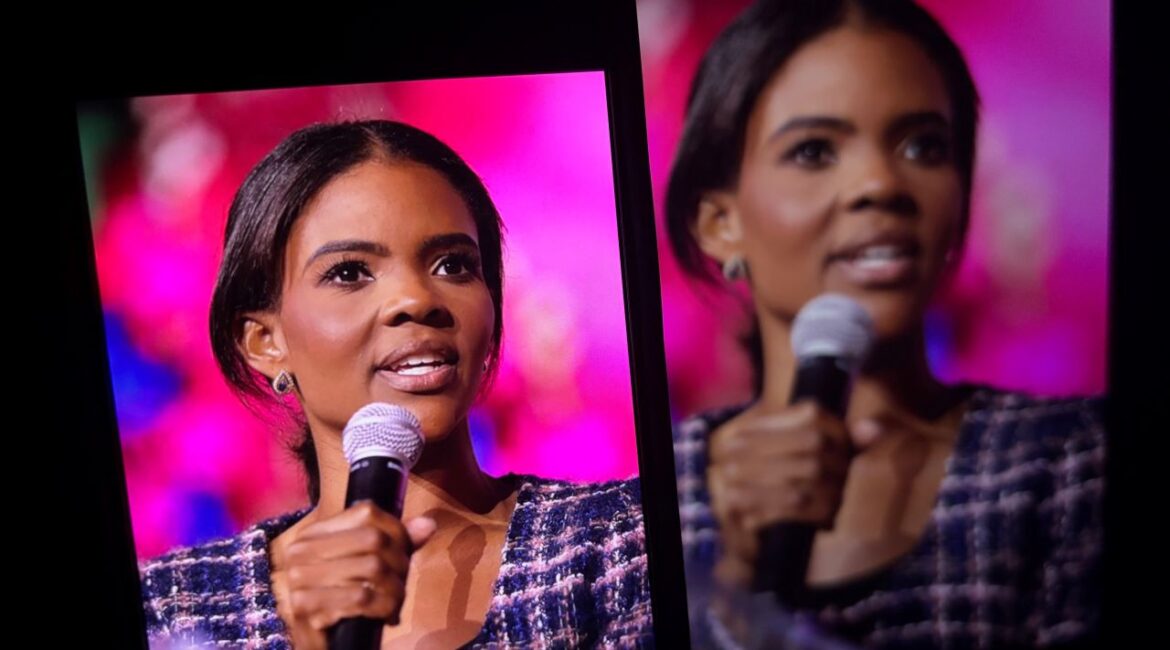 Images of Candace Owens speaking to an audience projected on screens in a room