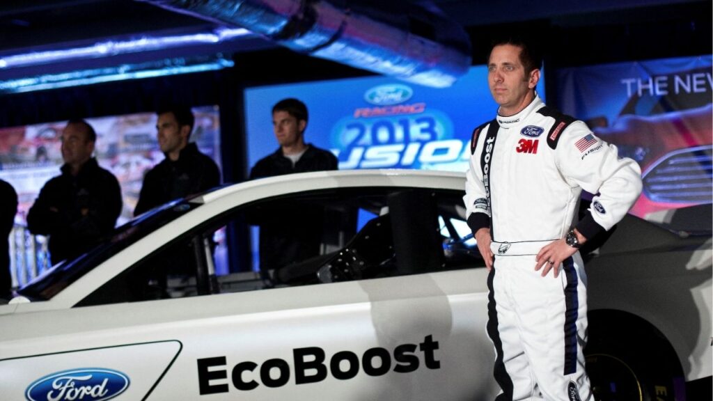 Driver Greg Biffle poses for photographs in front of the new 2013 Ford stock car after an announcement during the NASCAR Media Tour in Concord, North Carolina, January 24, 2012. (Reuters File)