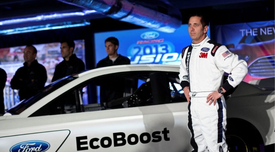 Driver Greg Biffle poses for photographs in front of the new 2013 Ford stock car after an announcement during the NASCAR Media Tour in Concord, North Carolina, January 24, 2012. (Reuters File)