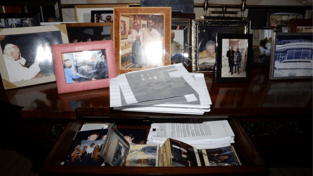 Image of a credenza covered in photographs at the home of Jeffrey Epstein.