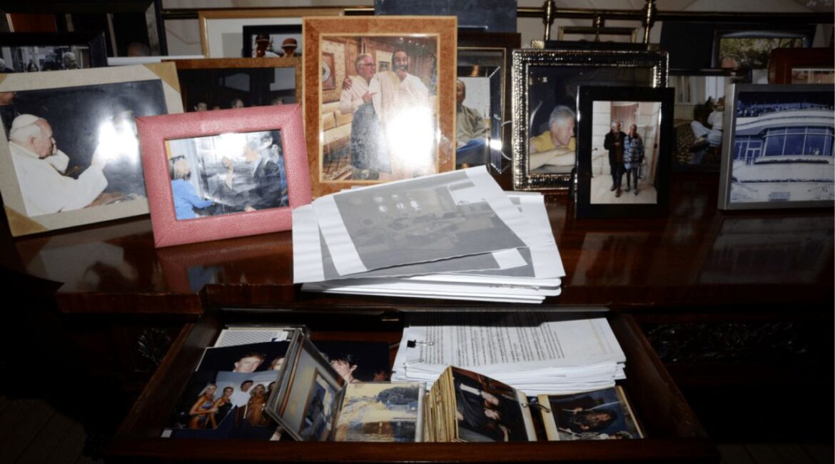 Image of a credenza covered in photographs at the home of Jeffrey Epstein.