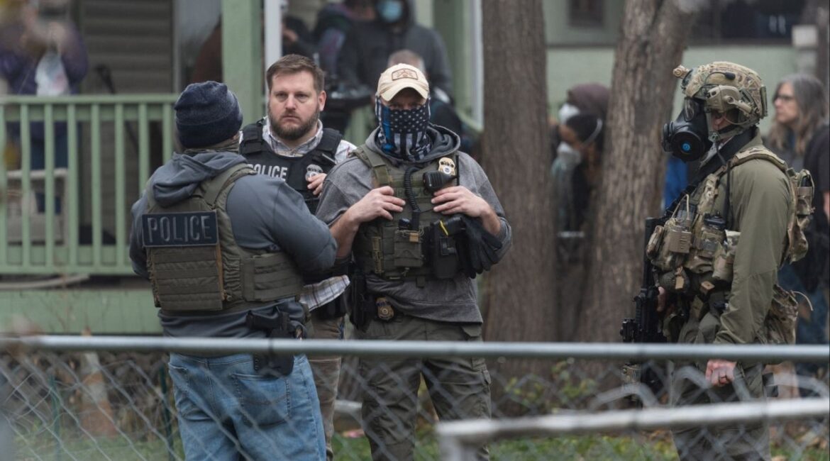 Federal officers from ICE and other agencies stand guard during an immigration raid of a home in St. Paul, Minnesota, U.S. November 25, 2025. (Reuters/Tim Evans)