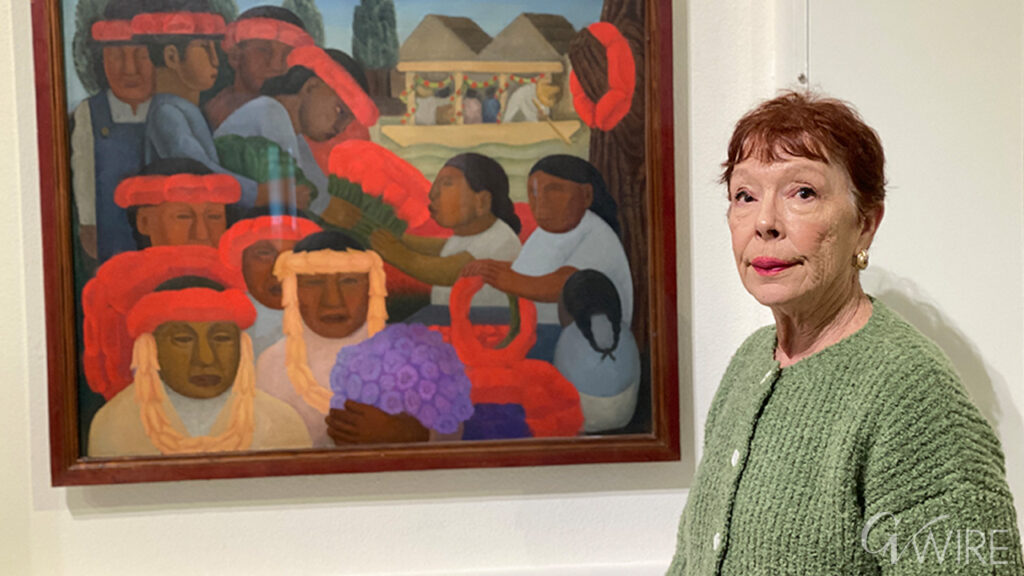 Fresno Art Museum Executive Director and Chief Curator Michele Ellis Pracy shows one of the museum's prized pieces, "Fiesta" by Diego Rivera