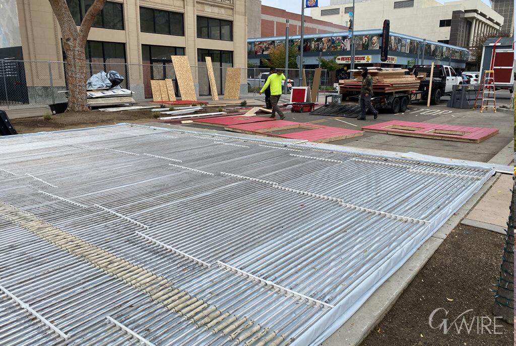 Fresno workers continue to construct a public ice rink, scheduled to open Dec. 5, 2025 at the Mariposa Plaza in downtown Fresno