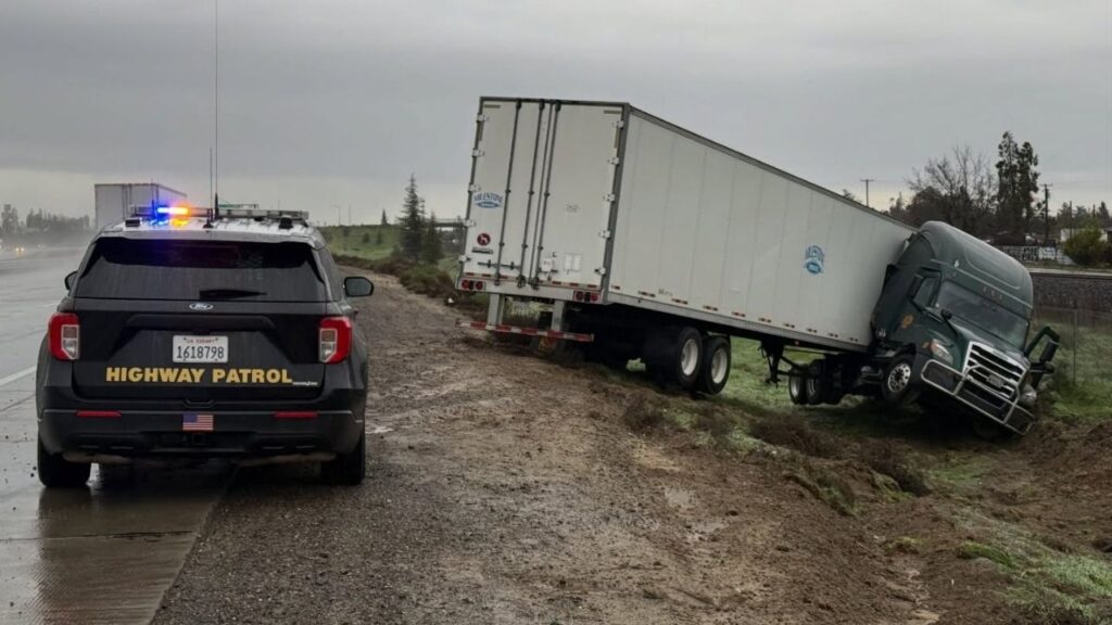 Heavy rain in Delhi caused a big rig to lose control and crash, prompting the CHP to warn drivers to slow down and allow extra space in wet conditions. (CHP)