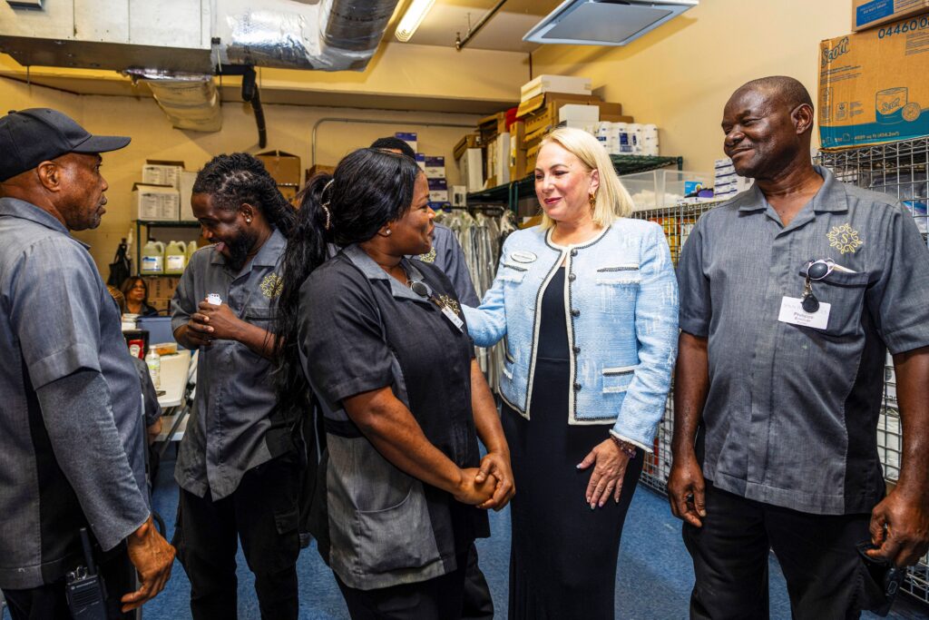 Image of a female white manager meeting with Black immigrant employees at a care home