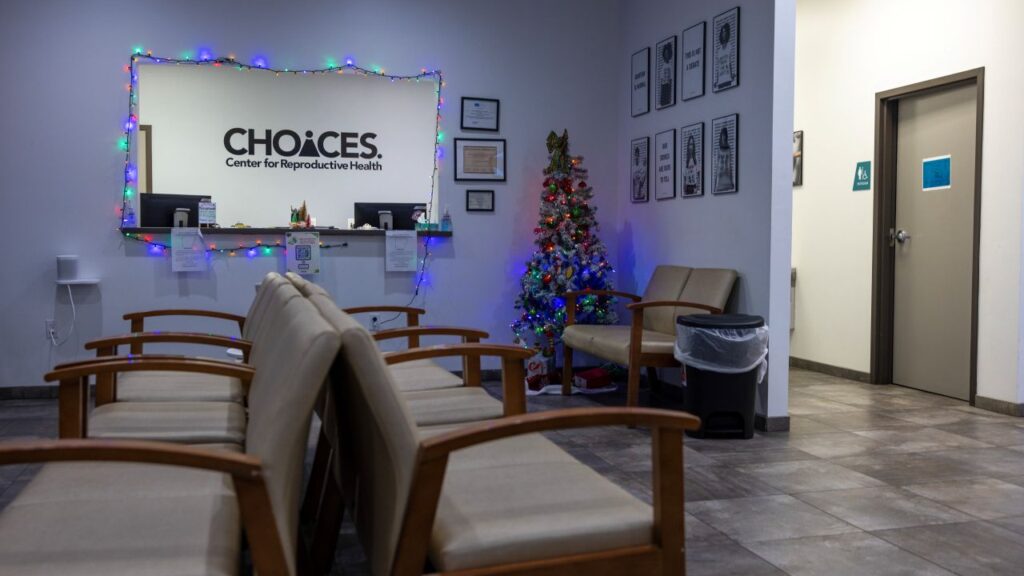 An image of an empty waiting room at the Choices abortion clinic. It is decorated for Christmas with twinkling lights.