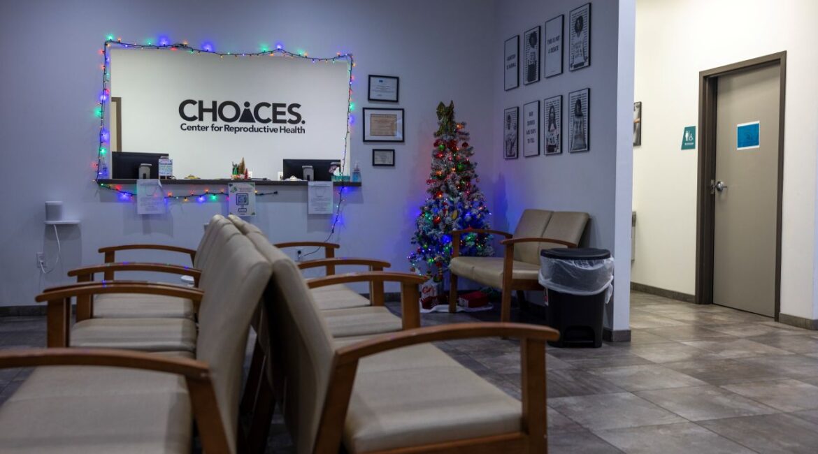 An image of an empty waiting room at the Choices abortion clinic. It is decorated for Christmas with twinkling lights.