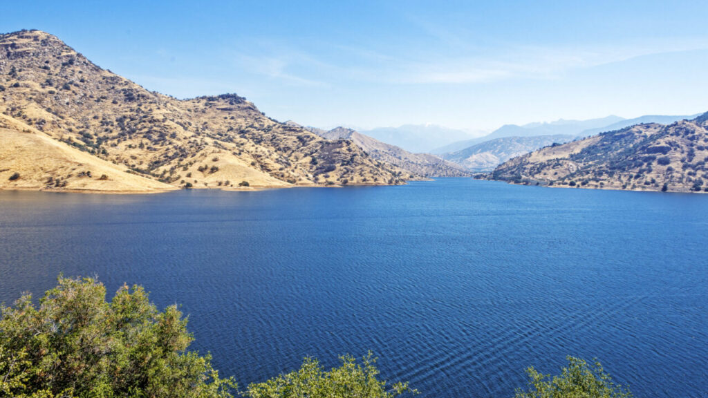 Image of Kaweah Lake with its blue water under blue skies and surrounding foothills