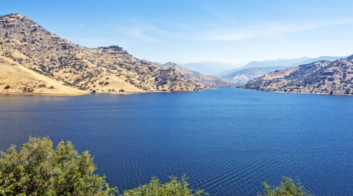 Image of Kaweah Lake with its blue water under blue skies and surrounding foothills