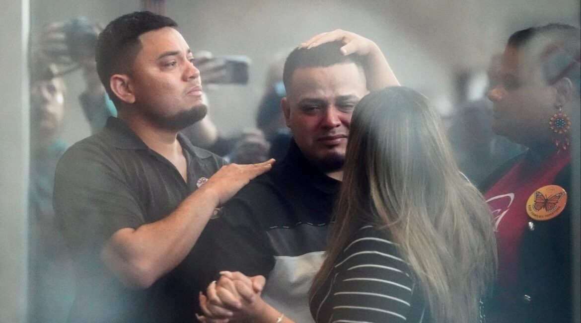 Kilmar Abrego, the migrant whose wrongful deportation to El Salvador made him a symbol of U.S. President Donald Trump's aggressive immigration policies, holds his wife Jennifer Vasquez Sura's hand, as he appears for a check-in at the ICE Baltimore field office three days after his release from criminal custody in Tennessee, in Baltimore, Maryland, U.S. August 25, 2025. Picture taken through glass. (Reuters/Elizabeth Frantz)