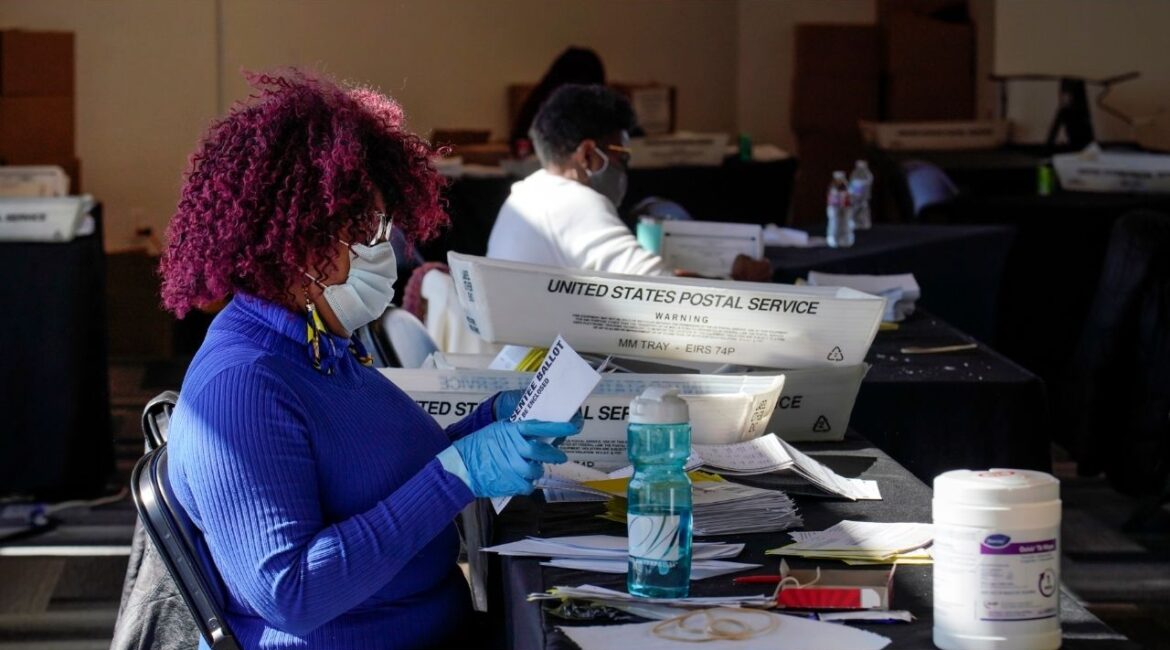 Mail-in ballots are processed in Atlanta on Nov. 2, 2020. The election interference case against President Donald Trump in Georgia was dismissed in late November 2025, but the ghosts of the 2020 election are still looming over the state as next year’s midterms approach. (Nicole Craine/The New York Times)