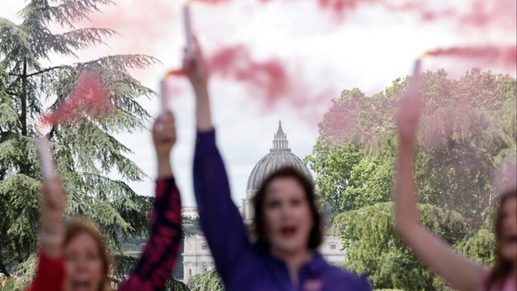 Members of the Catholic women's group, Women's Ordination Conference, hold flares of pink smoke, calling for women's equality in the Catholic church and in protest at the male-only conclave, in Rome, Italy, May 7, 2025. (Reuters/Matteo Minnella)