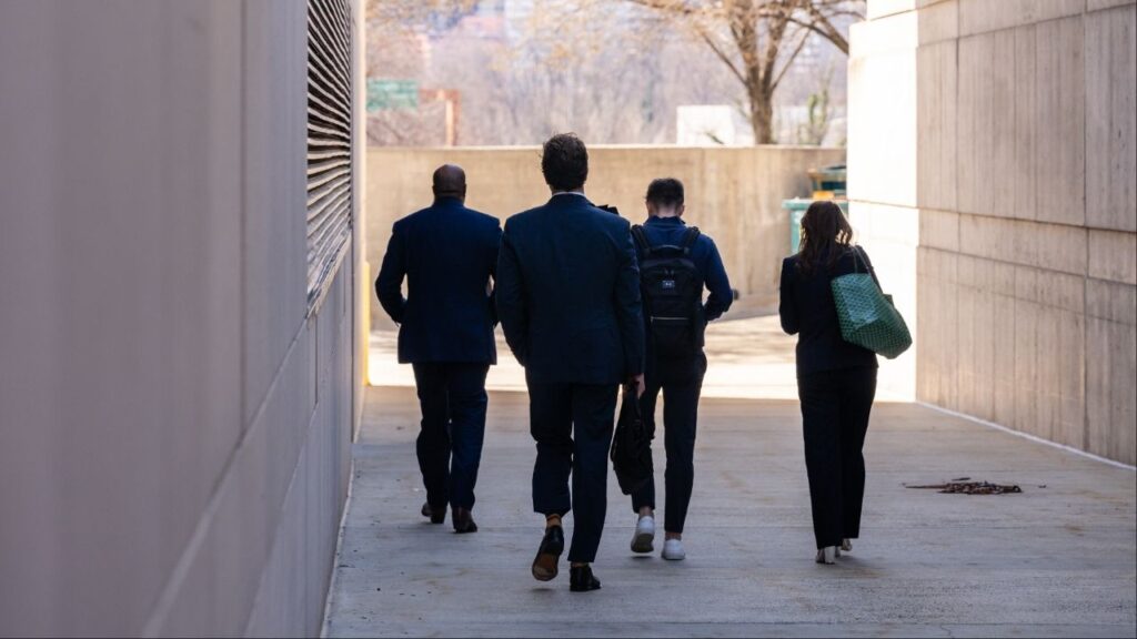 Members of the Department of Government Efficiency attempt to enter the U.S. Institutes of Peace in Washington, March 17, 2025. Elon Musk’s Department of Government Efficiency said it made more than 29,000 cuts to the federal government but the group did not do what Musk said it would: reduce federal spending by $1 trillion before October. On DOGE’s watch, federal spending did not go down at all. It went up. (Eric Lee/The New York Times) doge