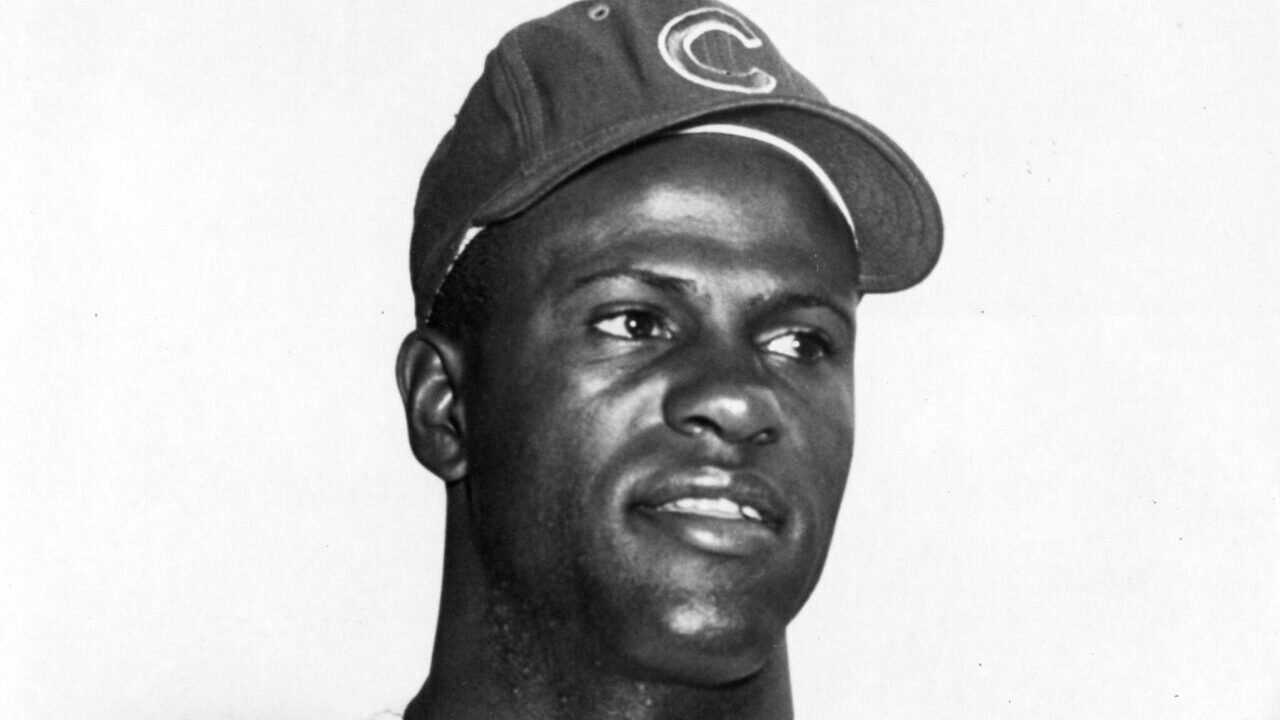 A black and white image of George Altman wearing a Chicago Cubs cap